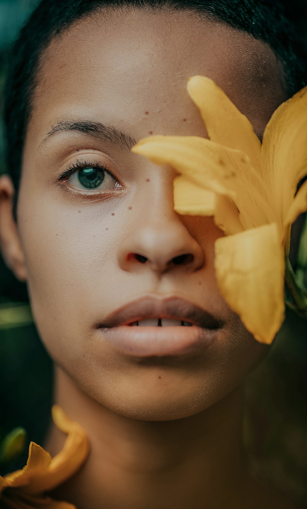 a close up of a person holding a flower