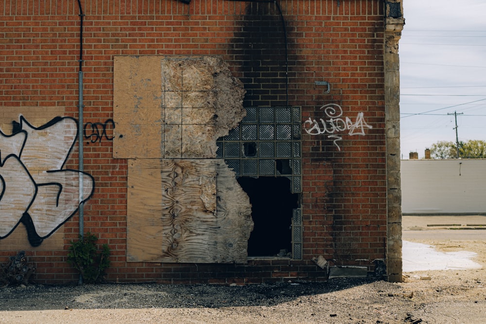 a brick building with graffiti on the side of it