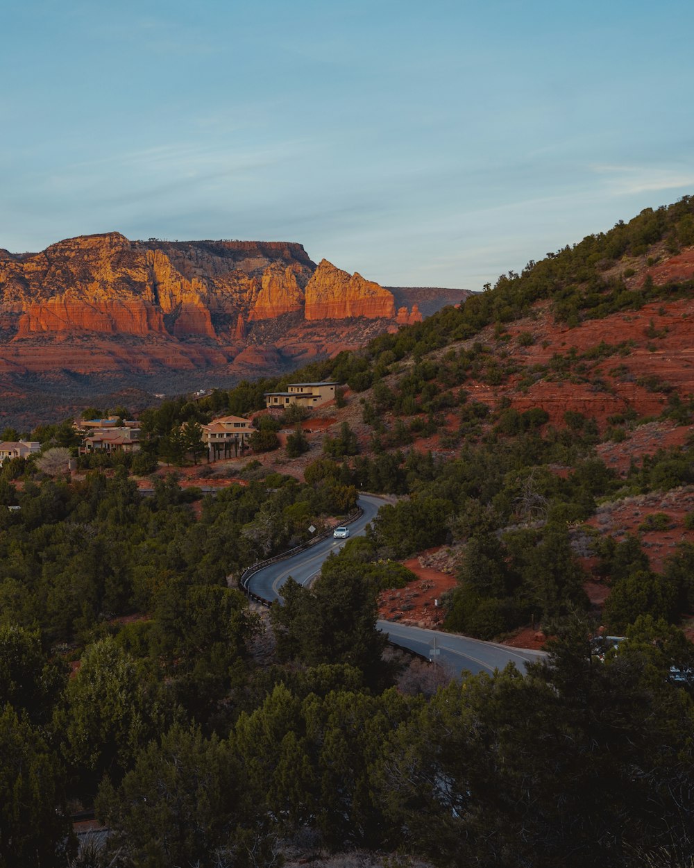 a scenic view of a mountain with a road going through it