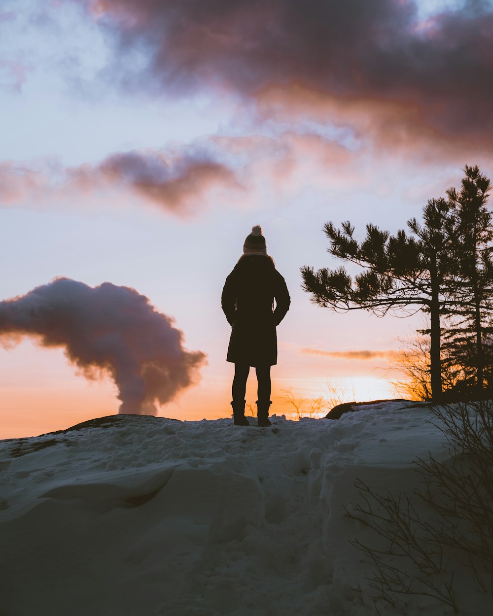 a person standing on top of a snow covered slope