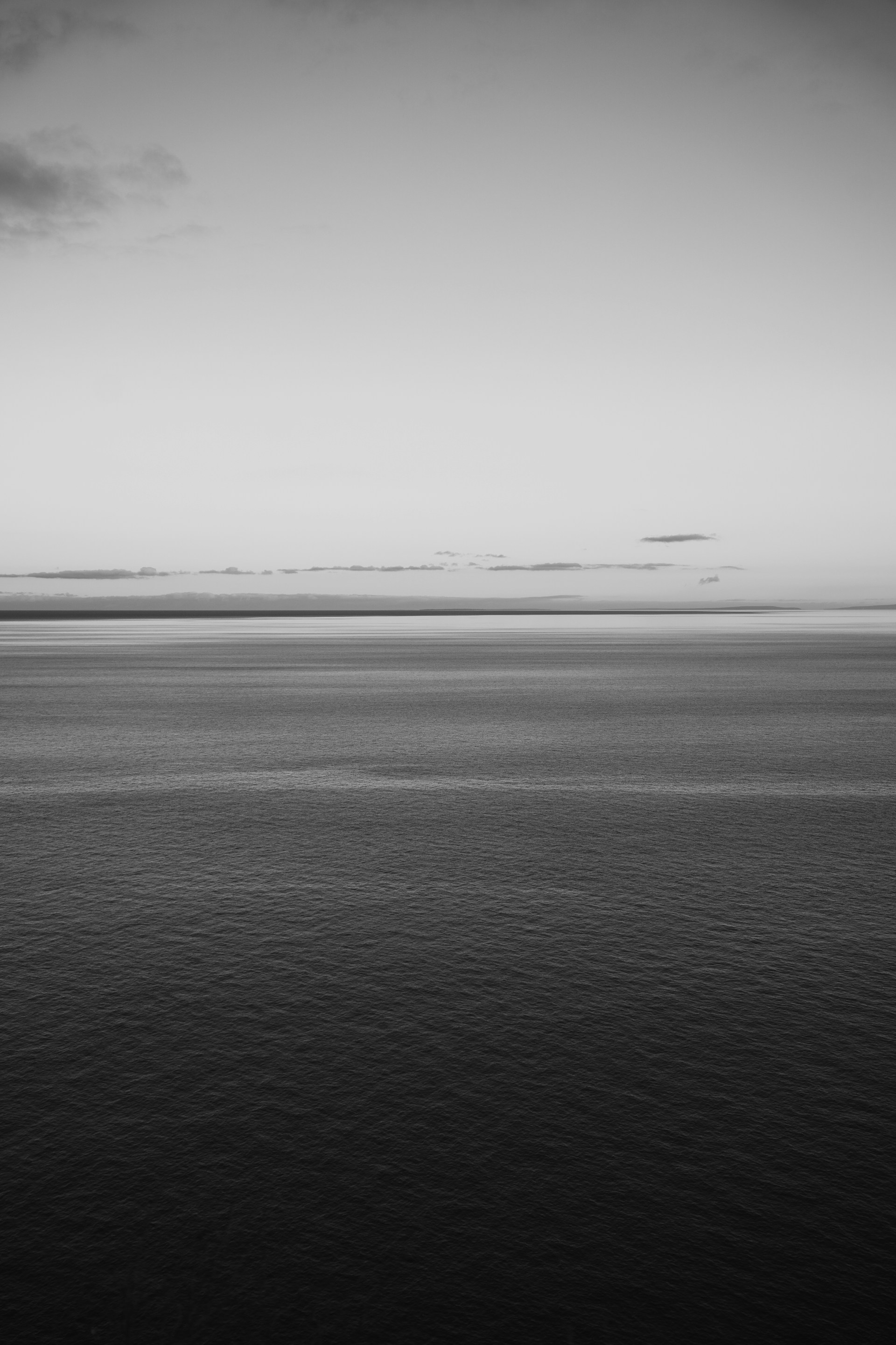 A tranquil seascape in monochrome, representing chaos and transformation.