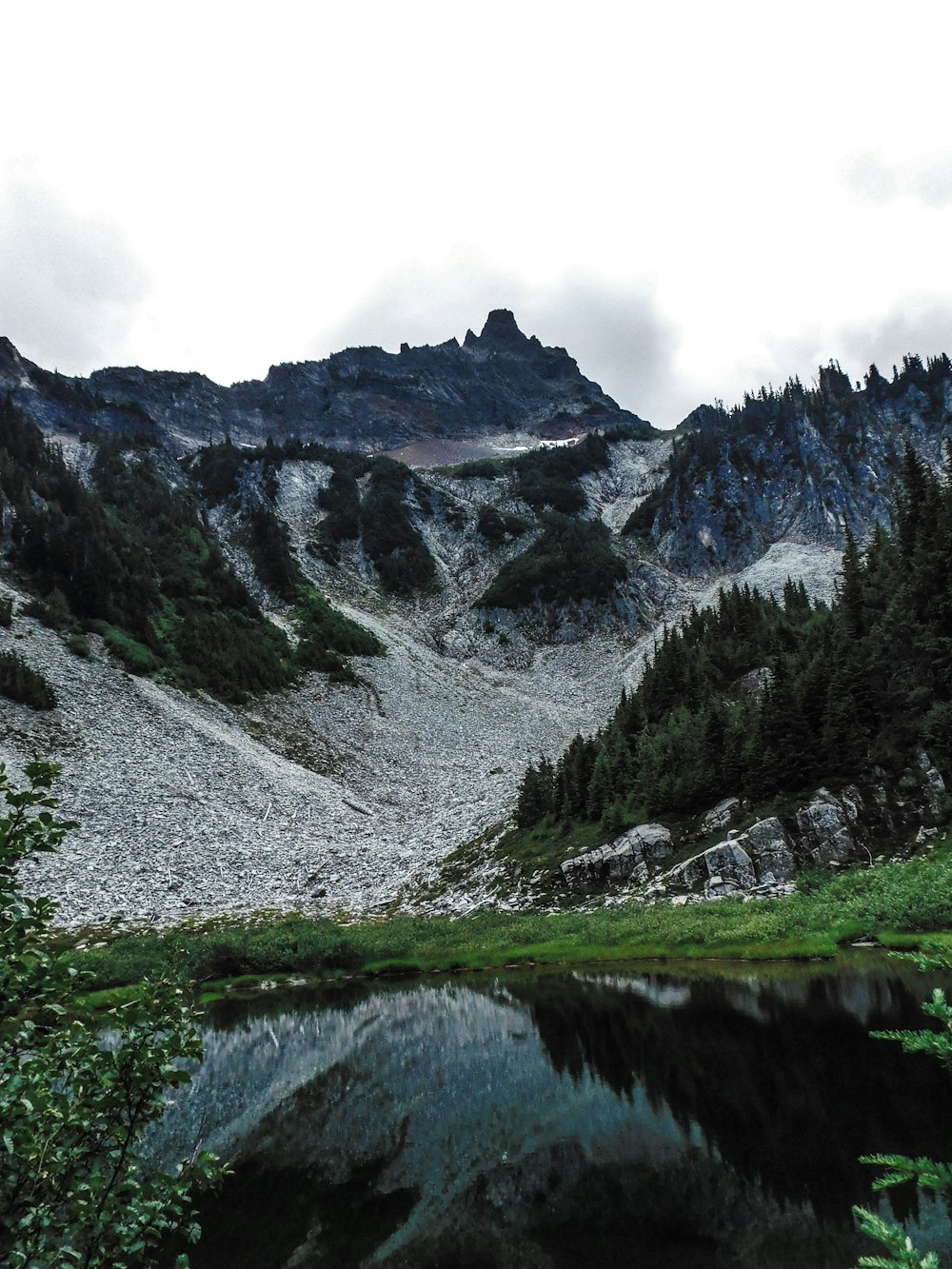 a mountain range with a lake in the foreground