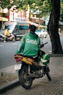 a man riding a motorcycle down a street
