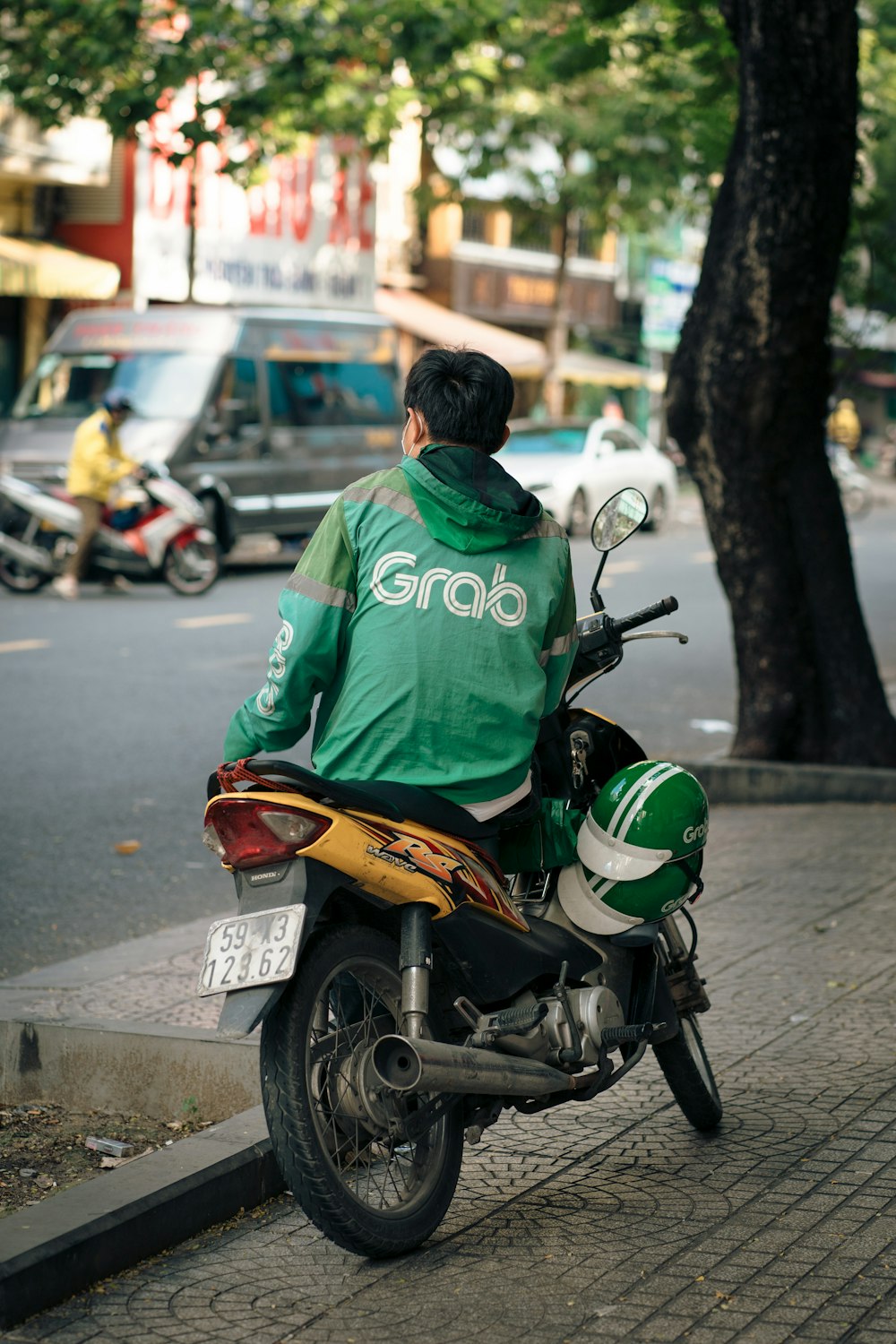 a man riding a motorcycle down a street