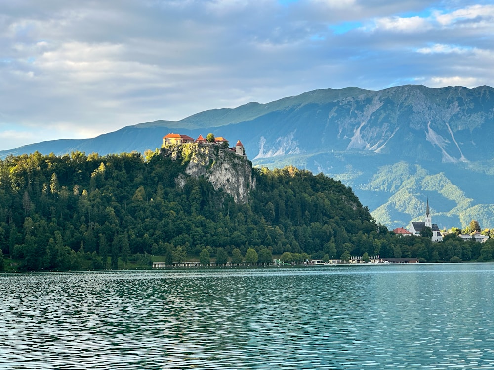 a castle on top of a mountain near a lake