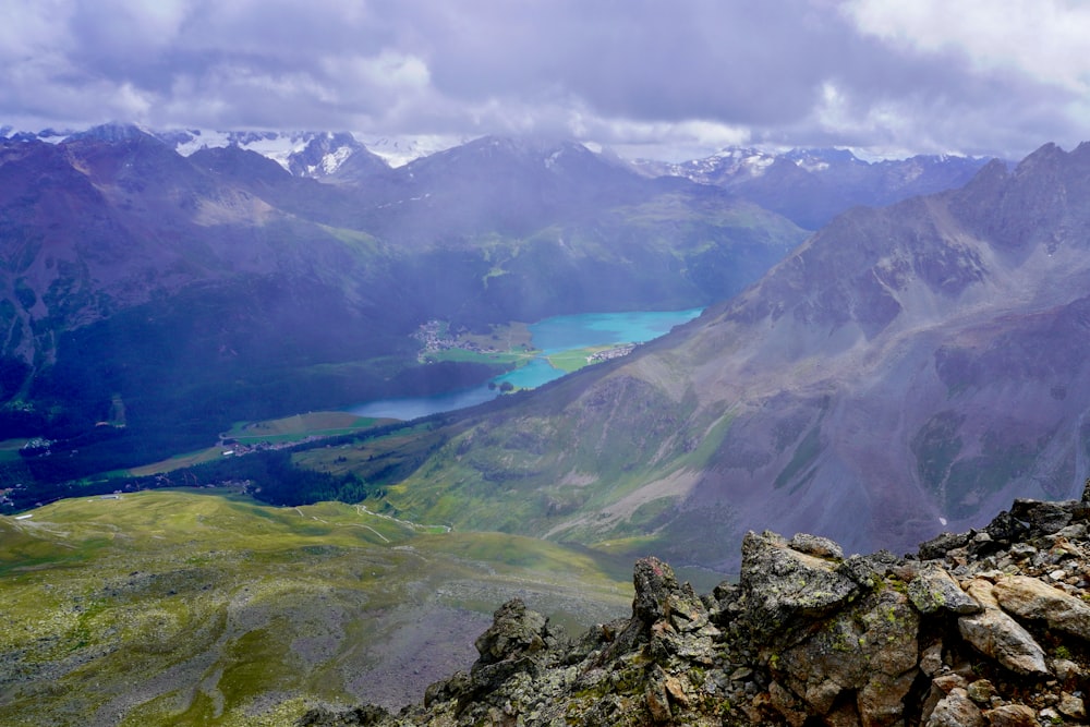 a view of a mountain range with a lake in the distance