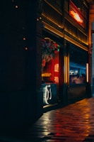 Night shot of a vibrant urban storefront illuminated with warm lighting.