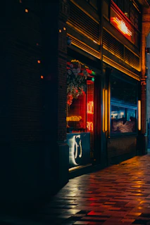 A cozy storefront of Reno Budz at 693 Broadway, Brooklyn, with a welcoming evening glow.