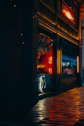 Night shot of a vibrant urban storefront illuminated with warm lighting.
