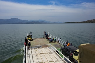 a ferry boat with people boarding it on the water