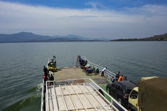 a ferry boat with people boarding it on the water