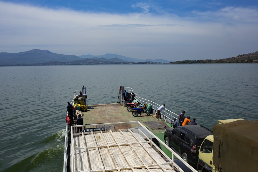 a ferry boat with people boarding it on the water