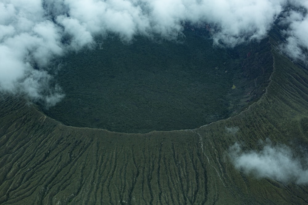 an aerial view of a crater in the clouds