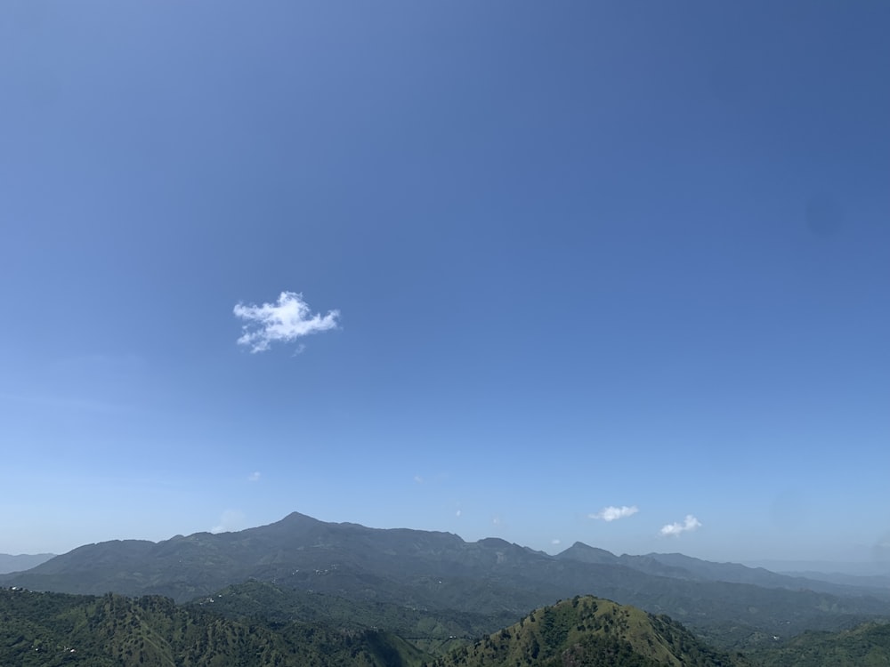 a view of a mountain range with a cloud in the sky