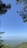 A scenic view of the Himalayas with lush greenery and a clear blue sky.