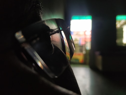 Close-up of a person using a computer with clear glasses.