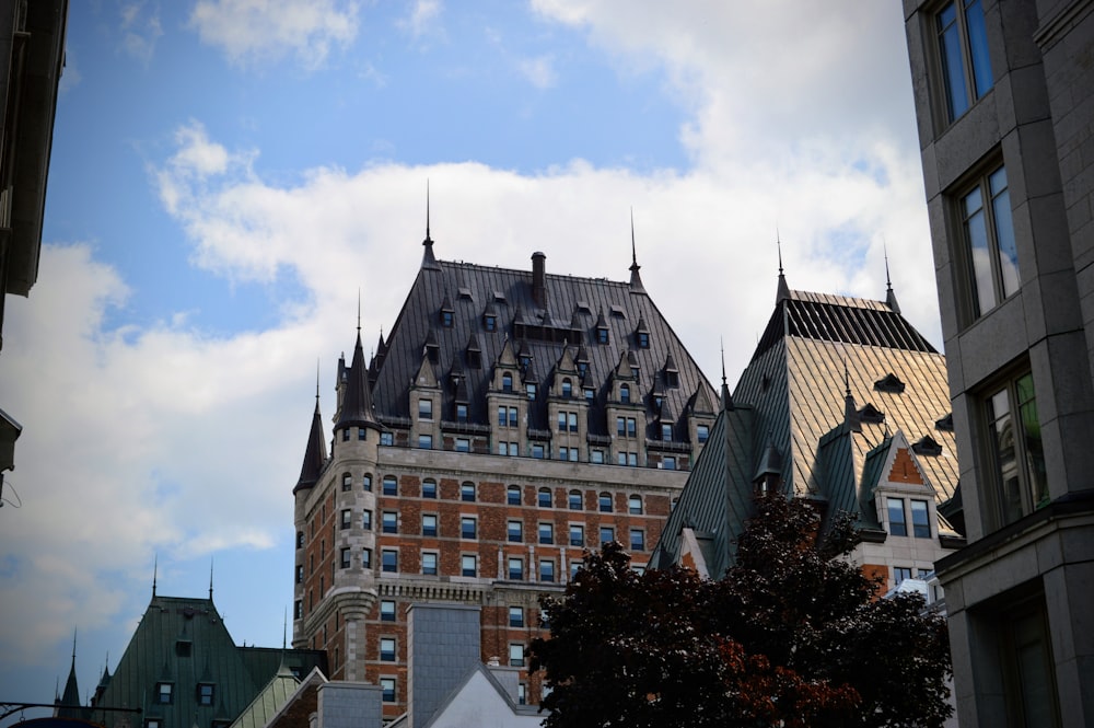 a tall building with many windows and a sky background