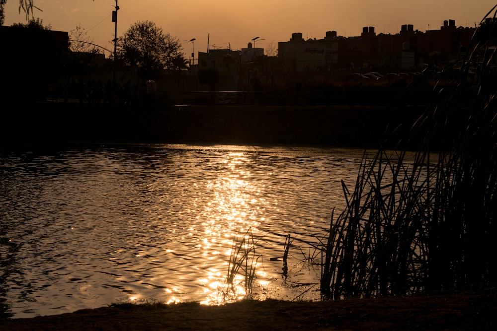 the sun is setting over a body of water