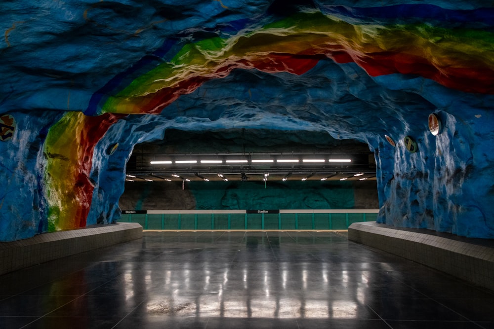 a tunnel with a rainbow painted on the side of it