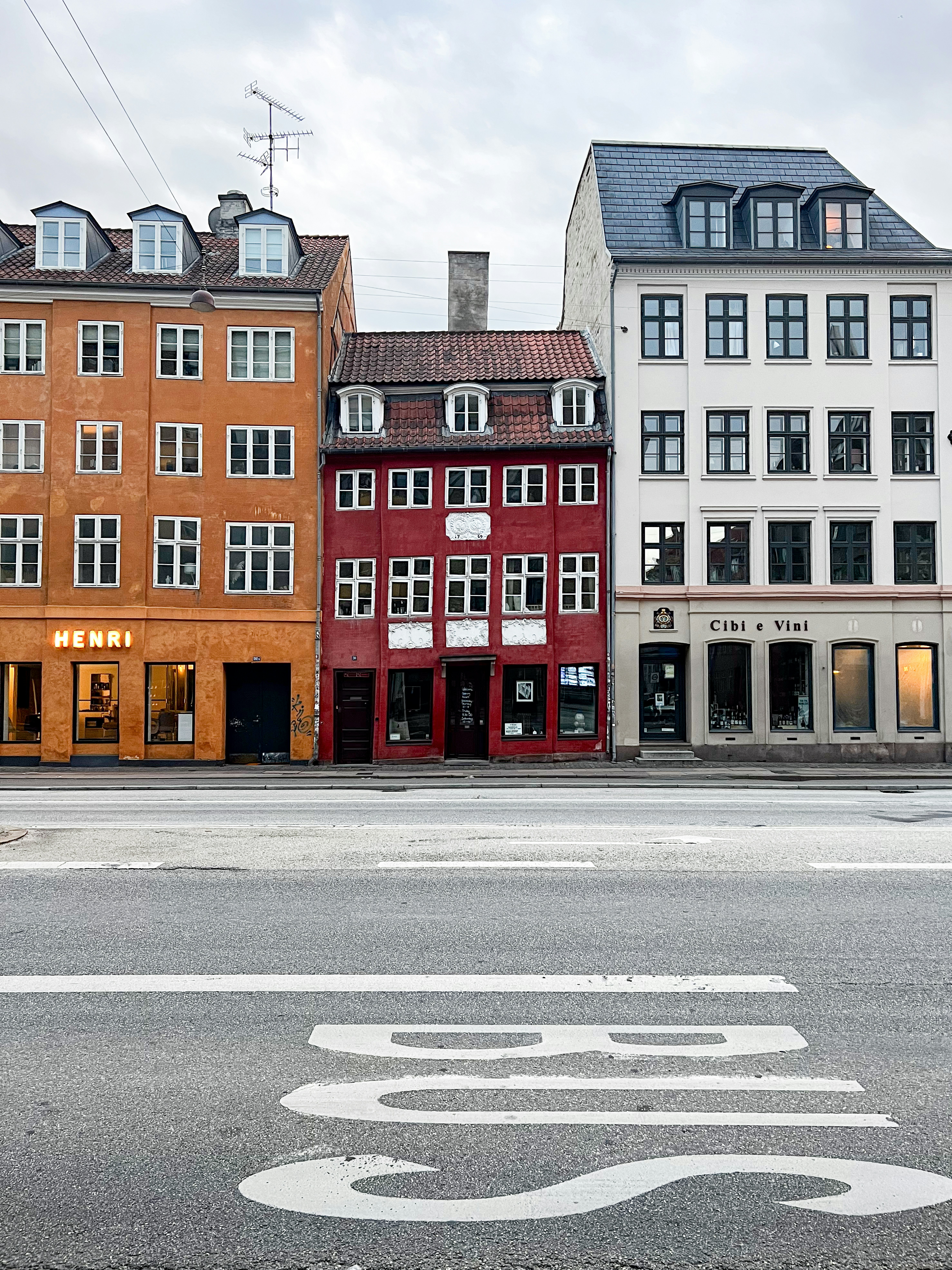 a row of buildings on the corner of a street