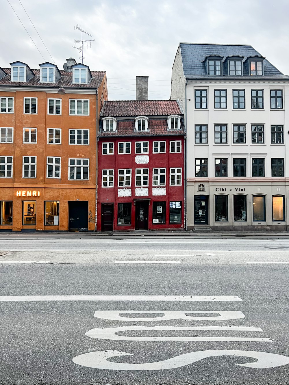 a row of buildings on the corner of a street