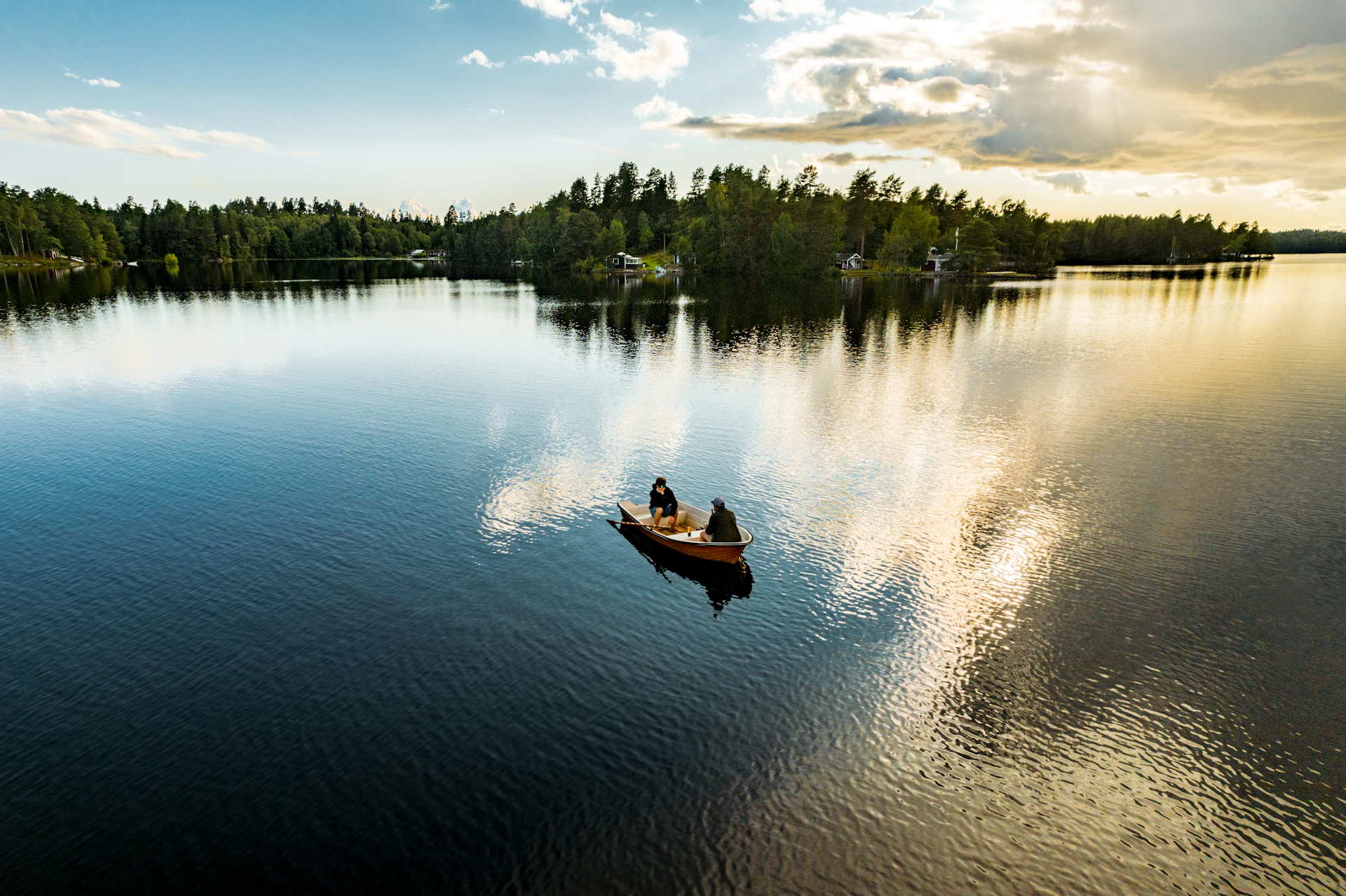 two people in a small boat on a lake