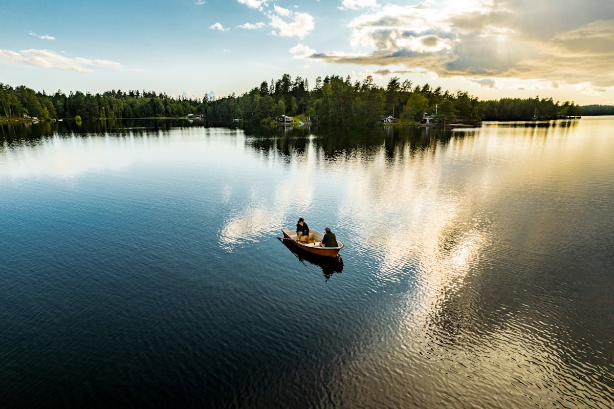 Small wooden ferry dock with kayaks at sunset in the Swedish archipelago
