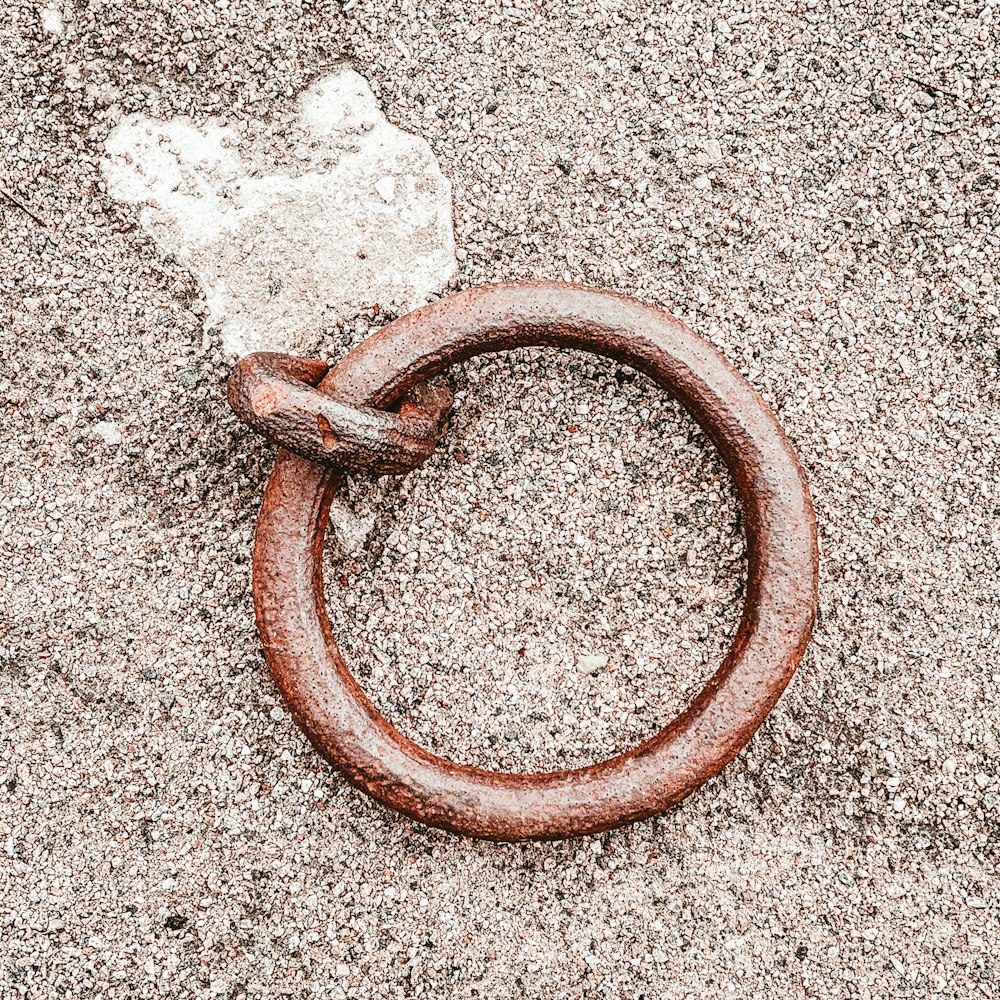 a rusted metal ring laying on the ground