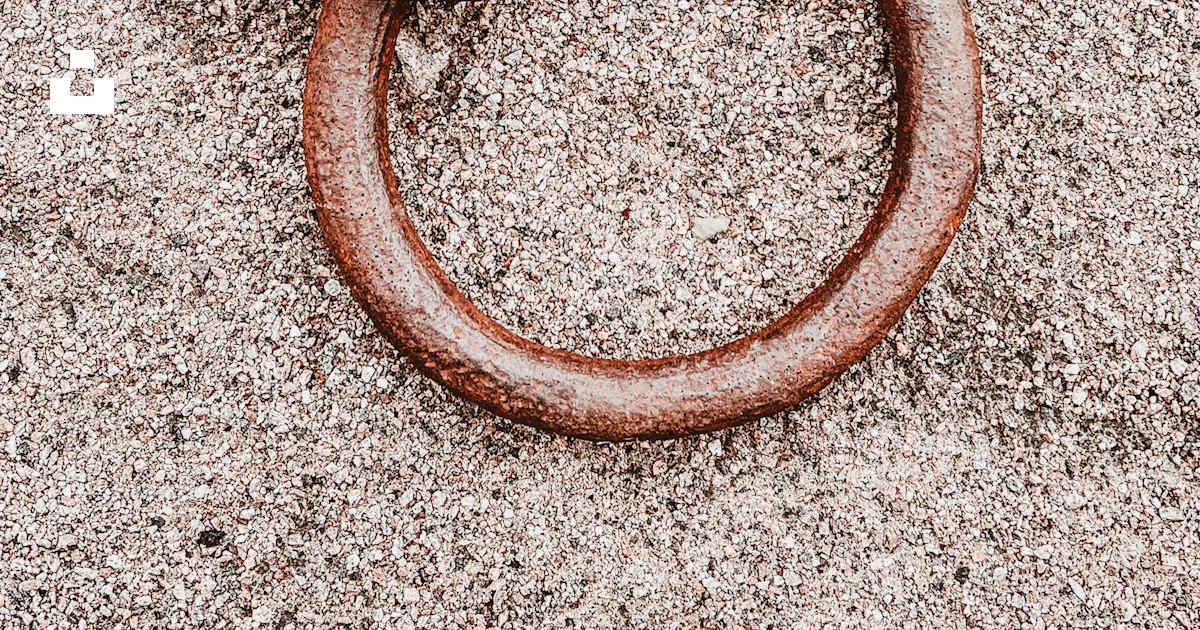 A rusted metal ring laying on the ground photo – Free Halmstad Image on ...