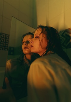 A thoughtful student looking into a mirror that shows abstract cognitive patterns.