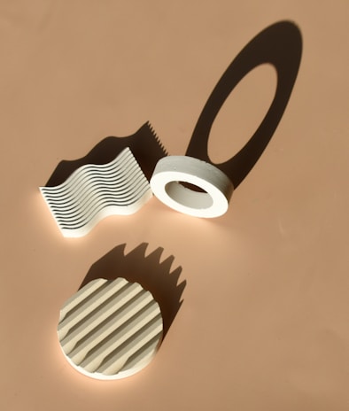 A minimalist still life emphasizing shadows and texture on a neutral background.