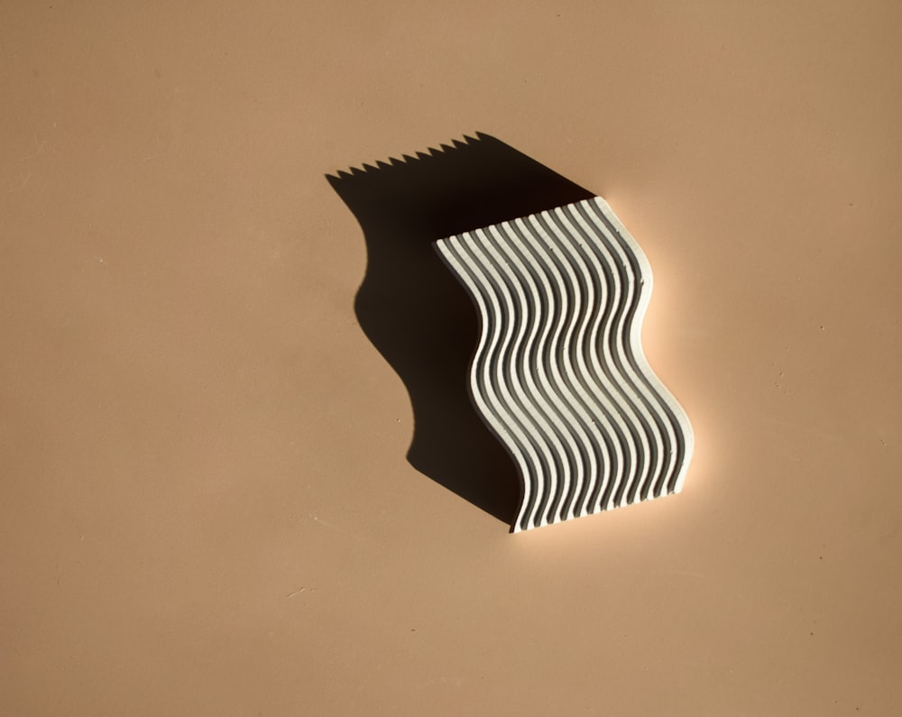 a black and white object on a brown surface