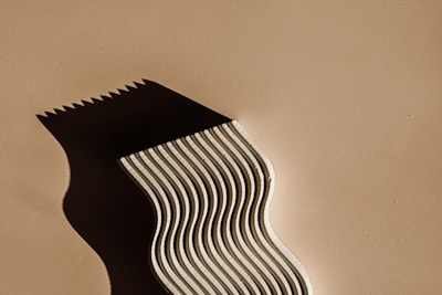 A multi-layered sculpture casting complex shadows that evoke emotion.