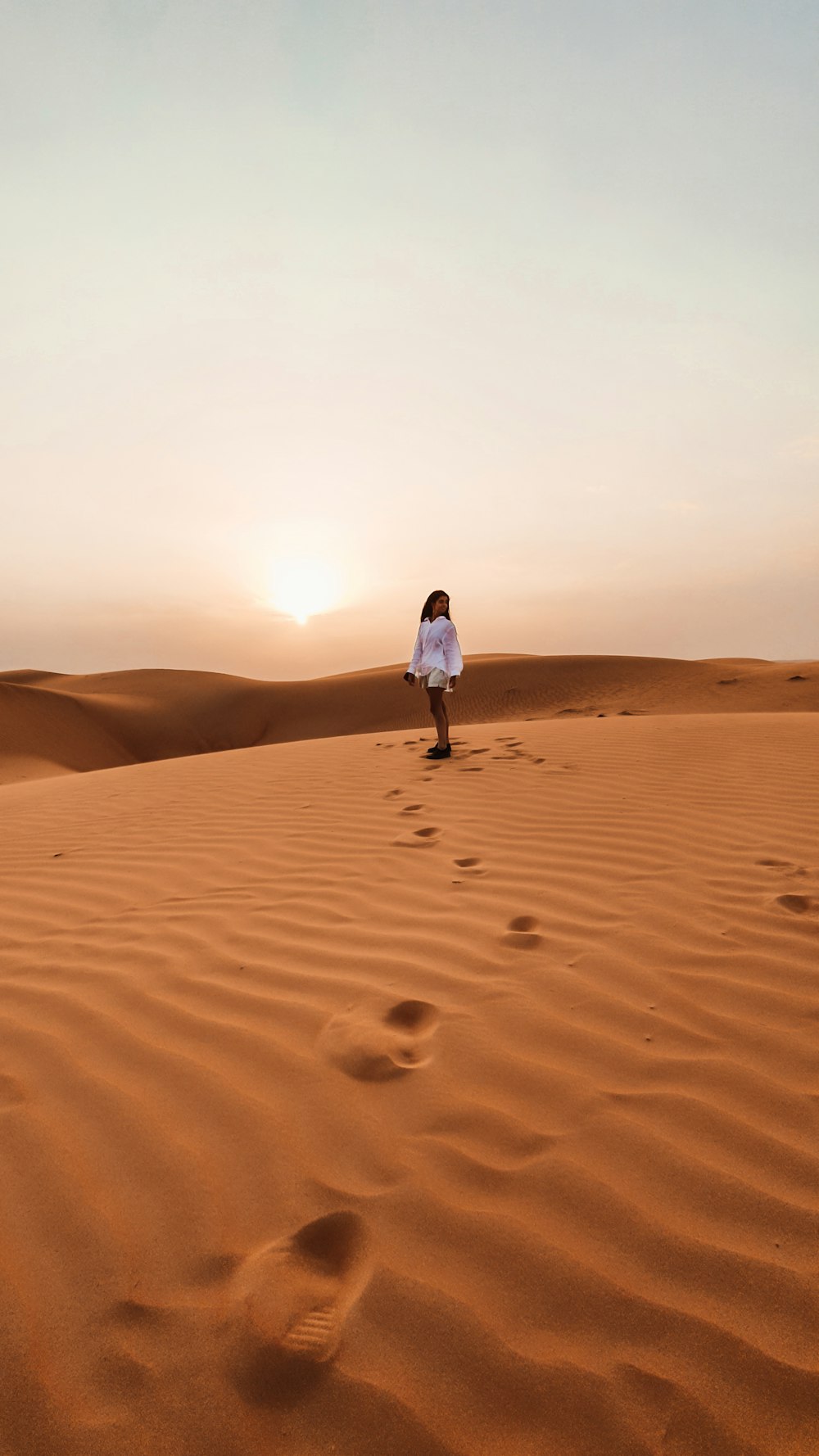 a person standing in the middle of a desert