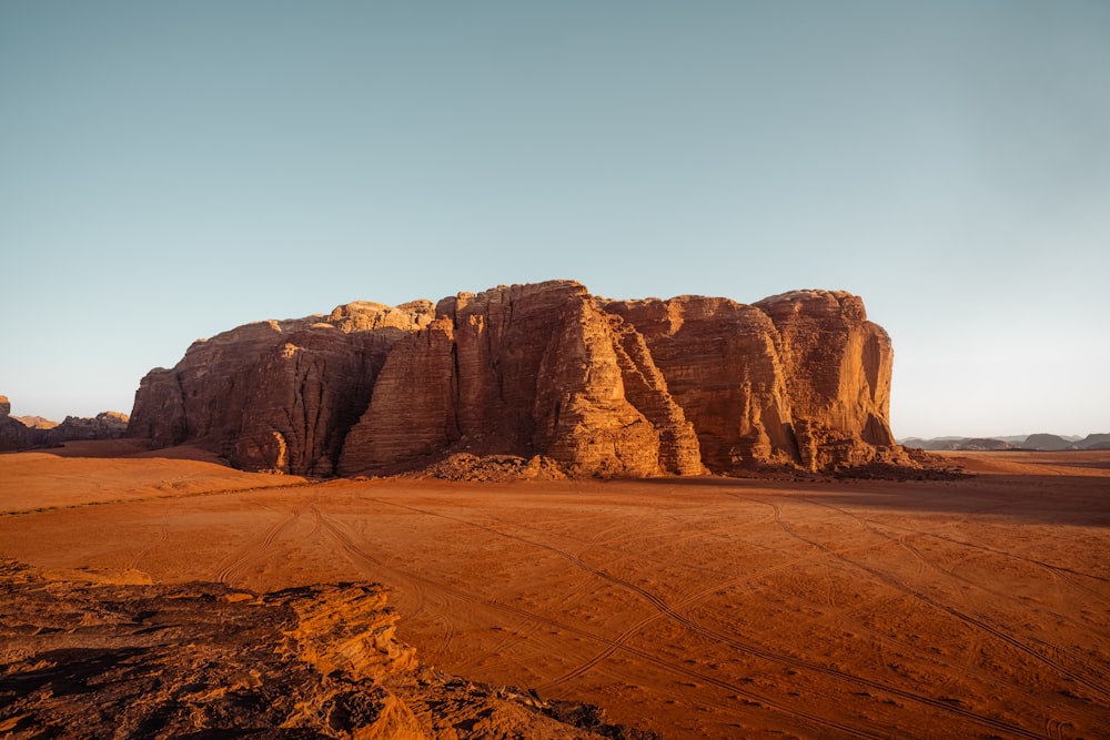 a large rock formation in the middle of a desert