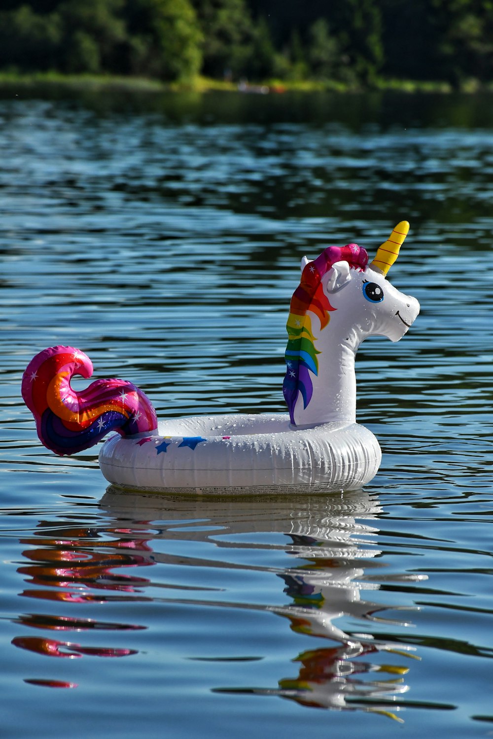 a paper mache of a unicorn floating on a lake