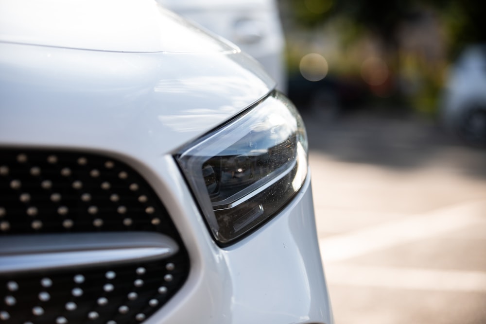 a close up of the front of a white car