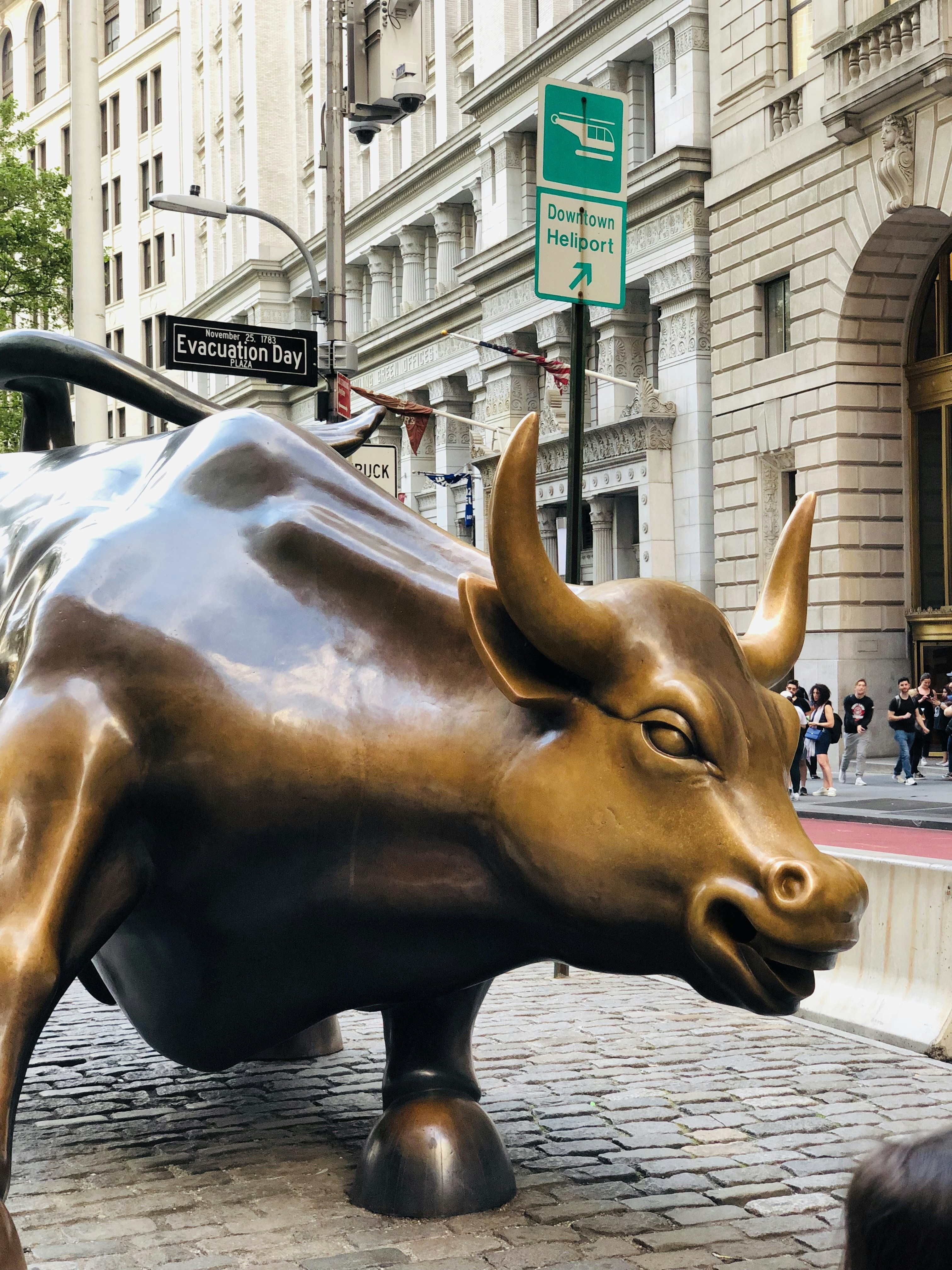 A statue of a bull on a city street