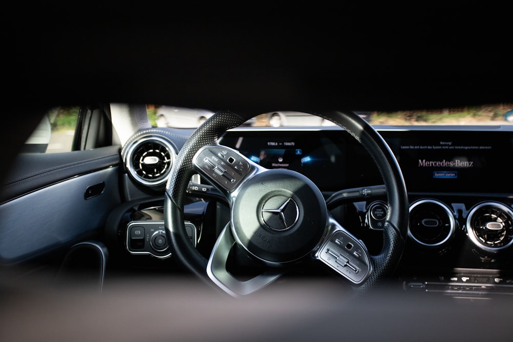 the interior of a car with a steering wheel and dashboard