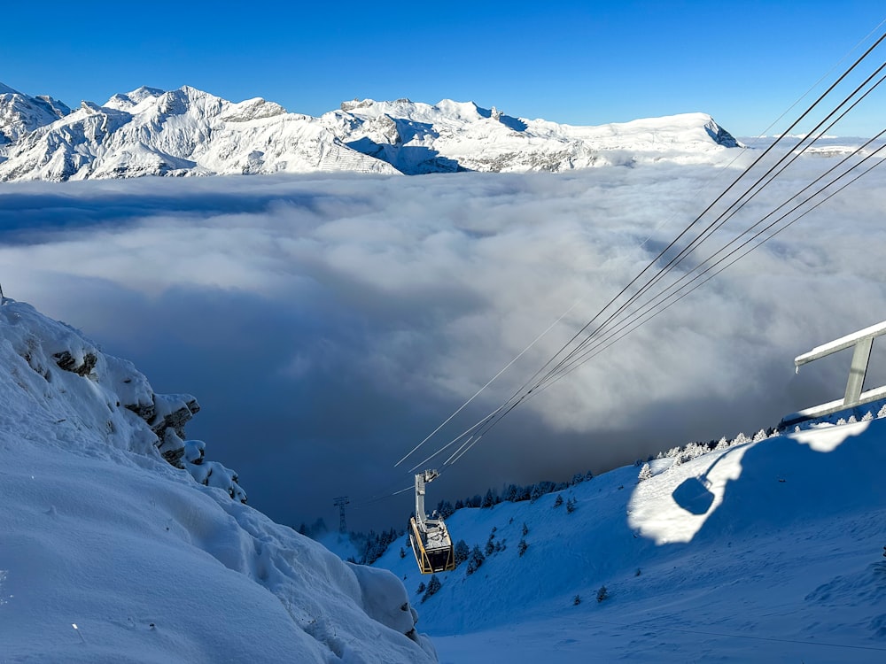 a ski lift going up a snowy mountain