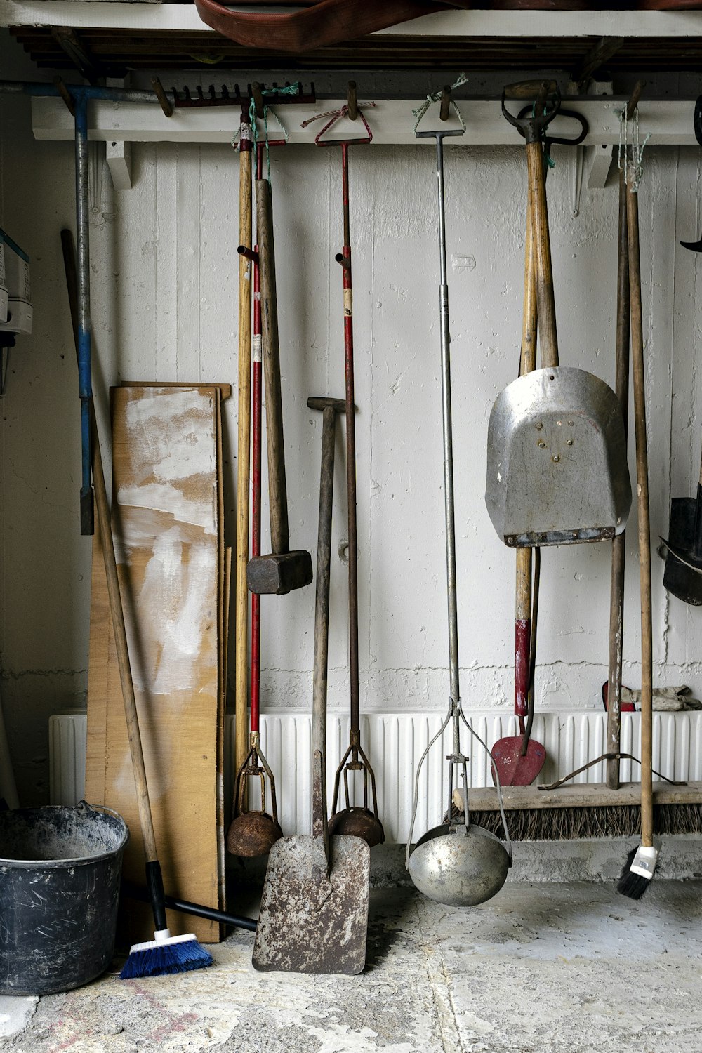 a bunch of tools are hanging on a wall