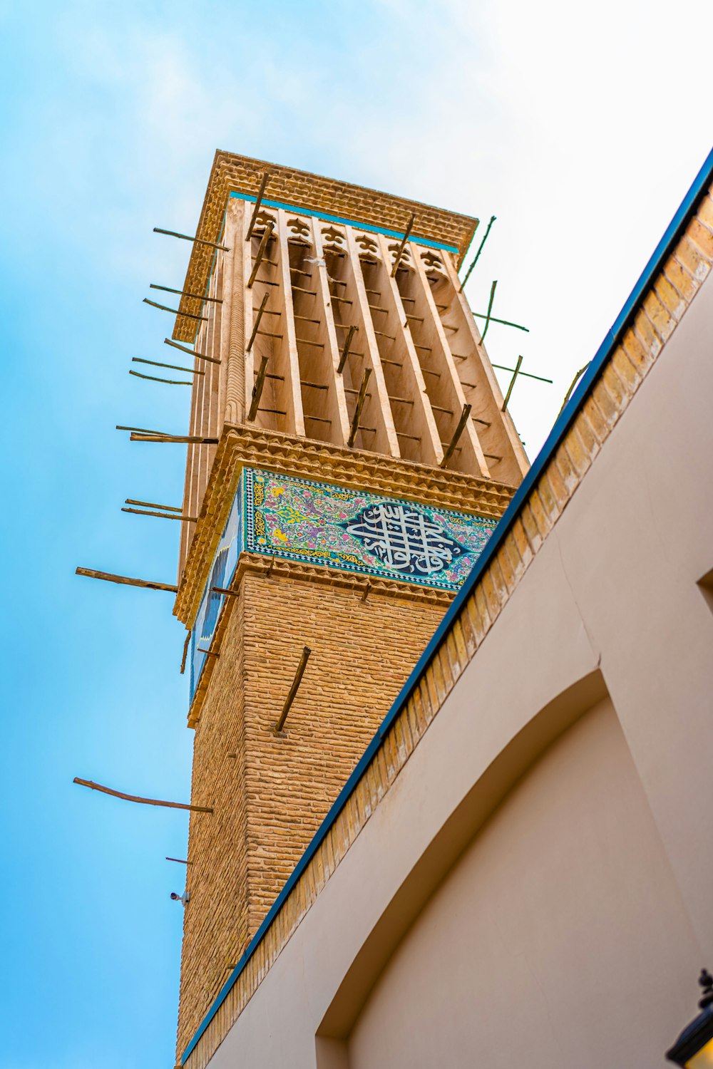 a tall brick clock tower with a sky background