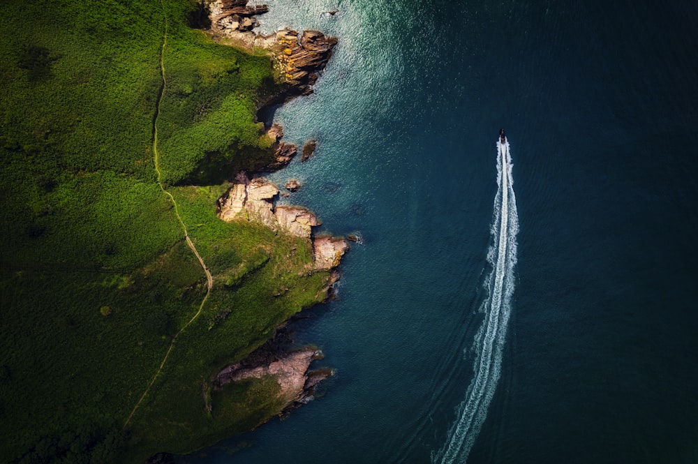 an aerial view of a boat in the water