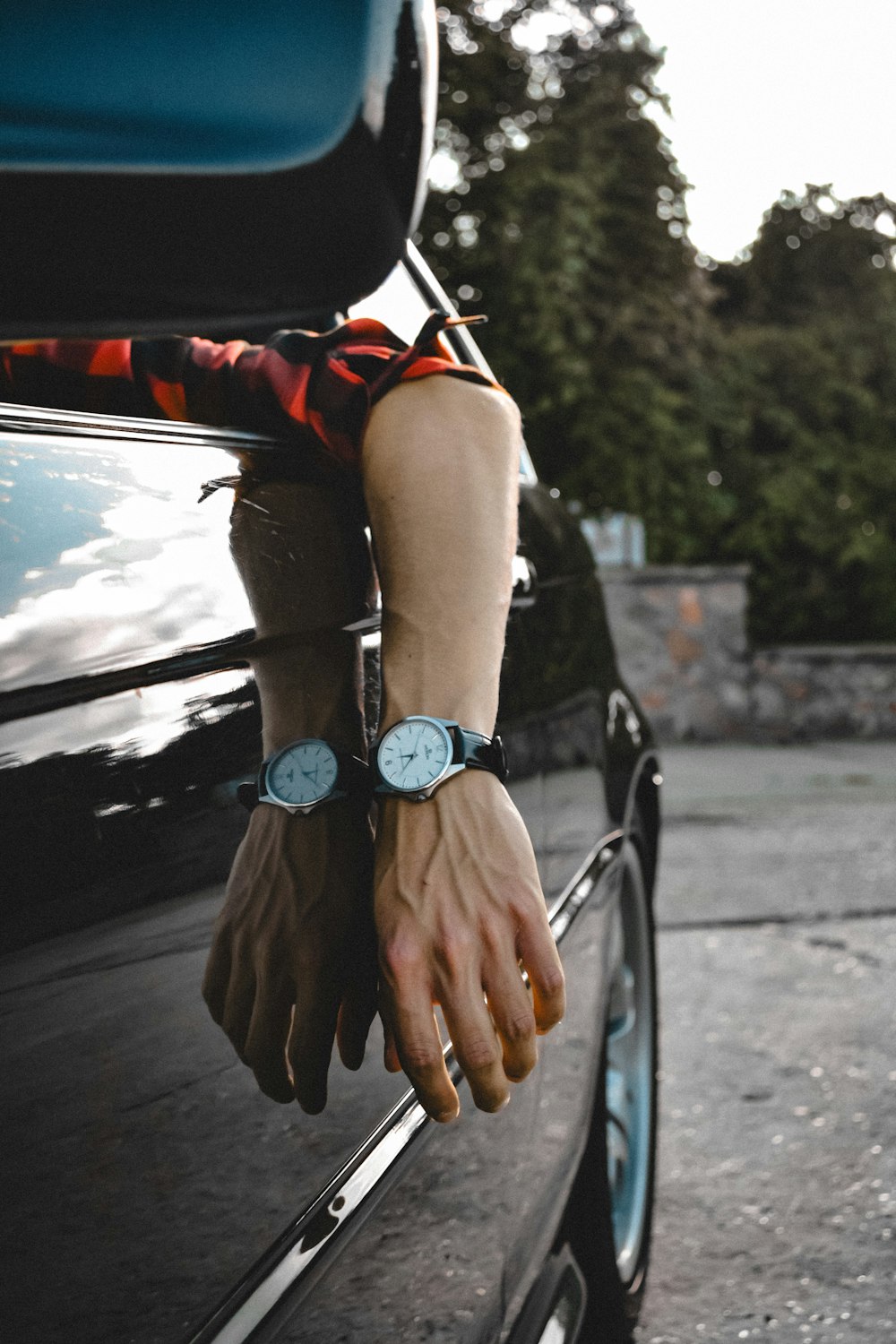 a person's hand on the door of a car