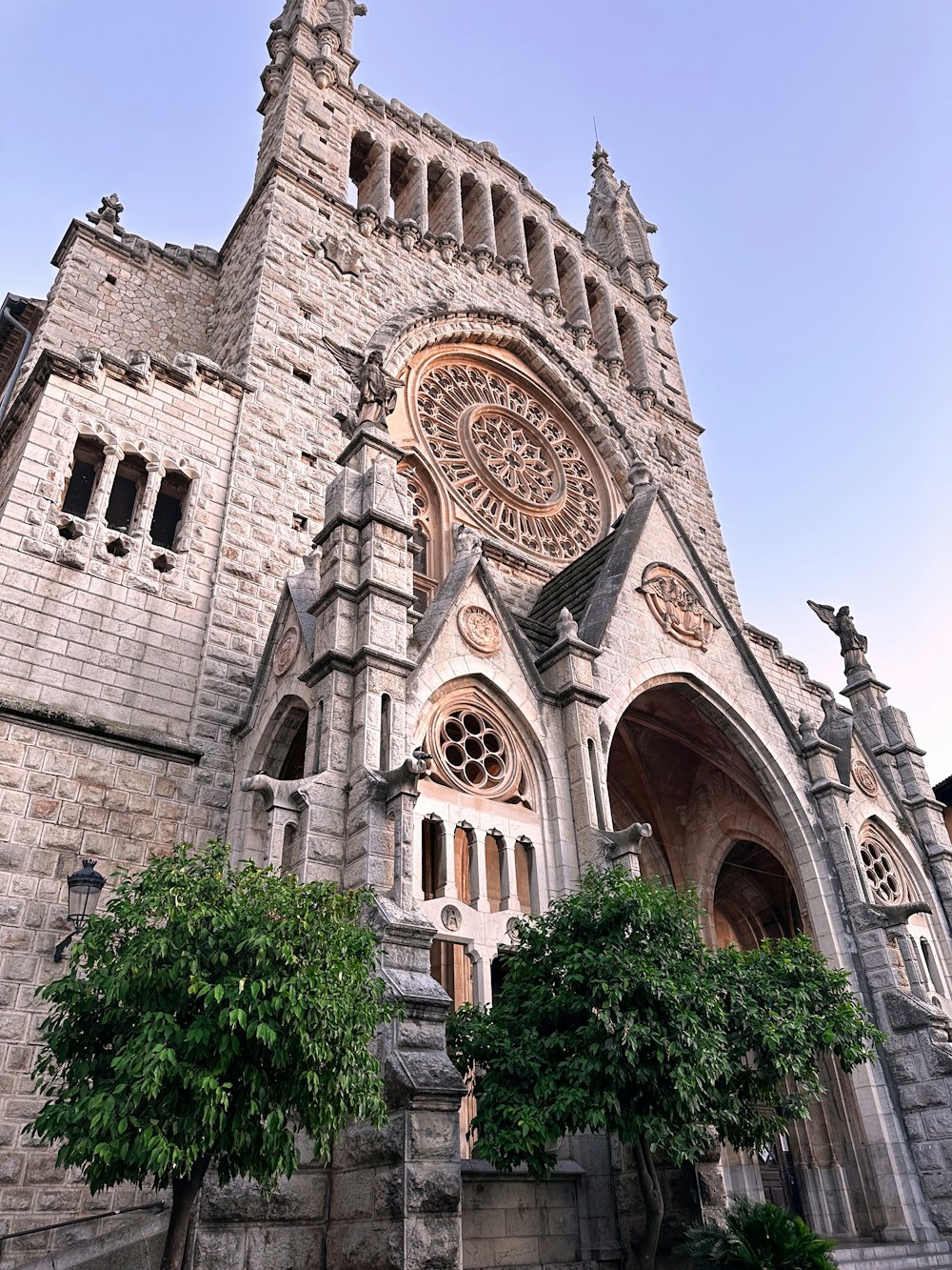 a large stone building with a clock on it's side