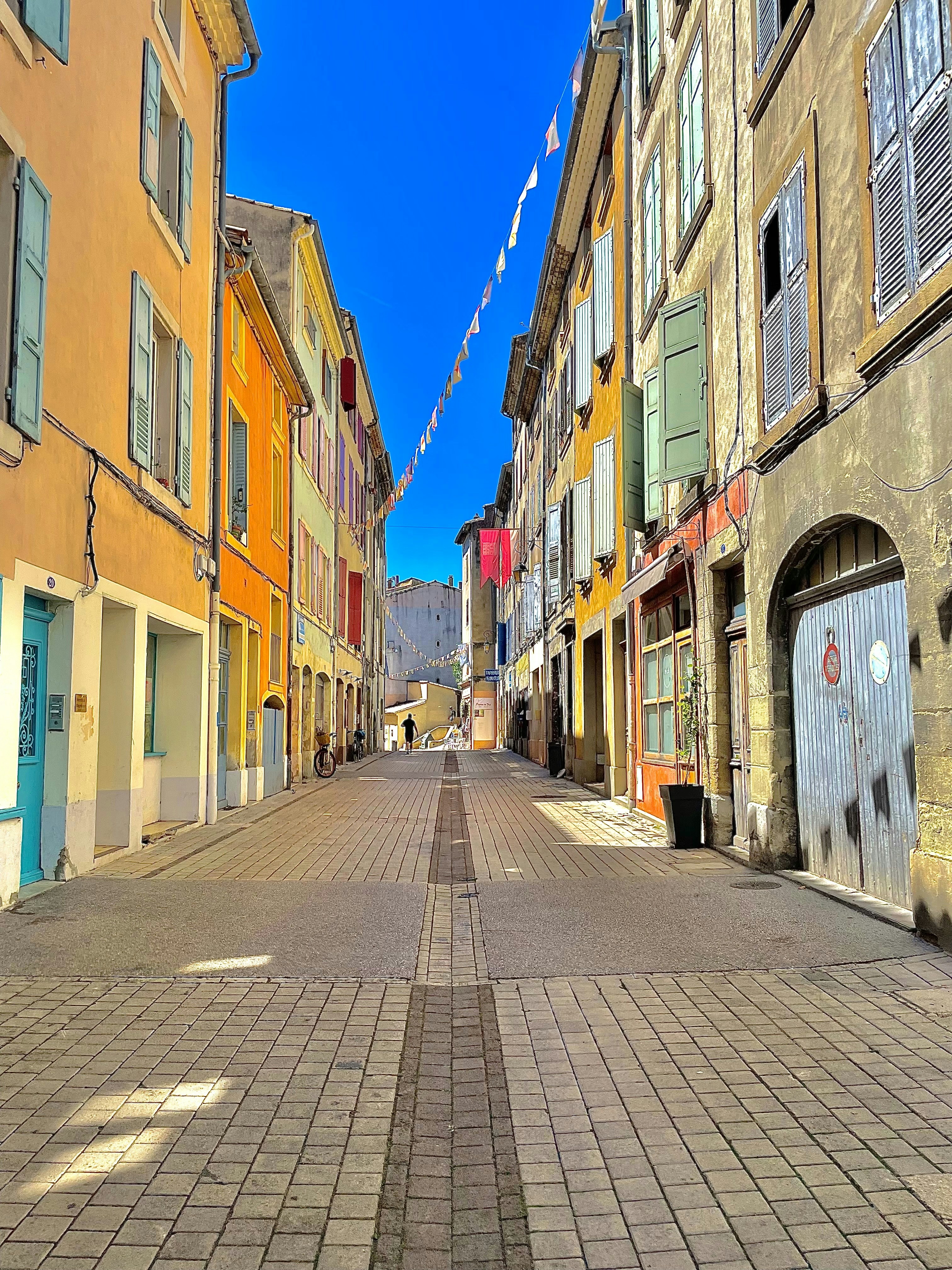 an empty street with a few buildings on both sides