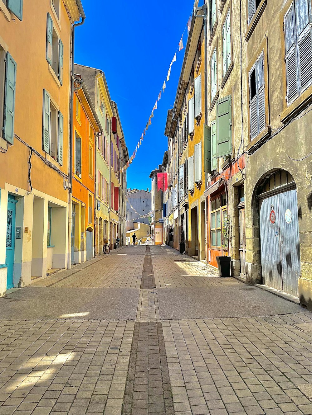 an empty street with a few buildings on both sides