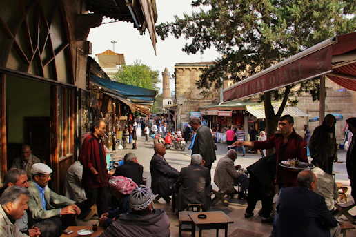A lively street stand with people sharing coffee and snacks, smiling and chatting warmly.