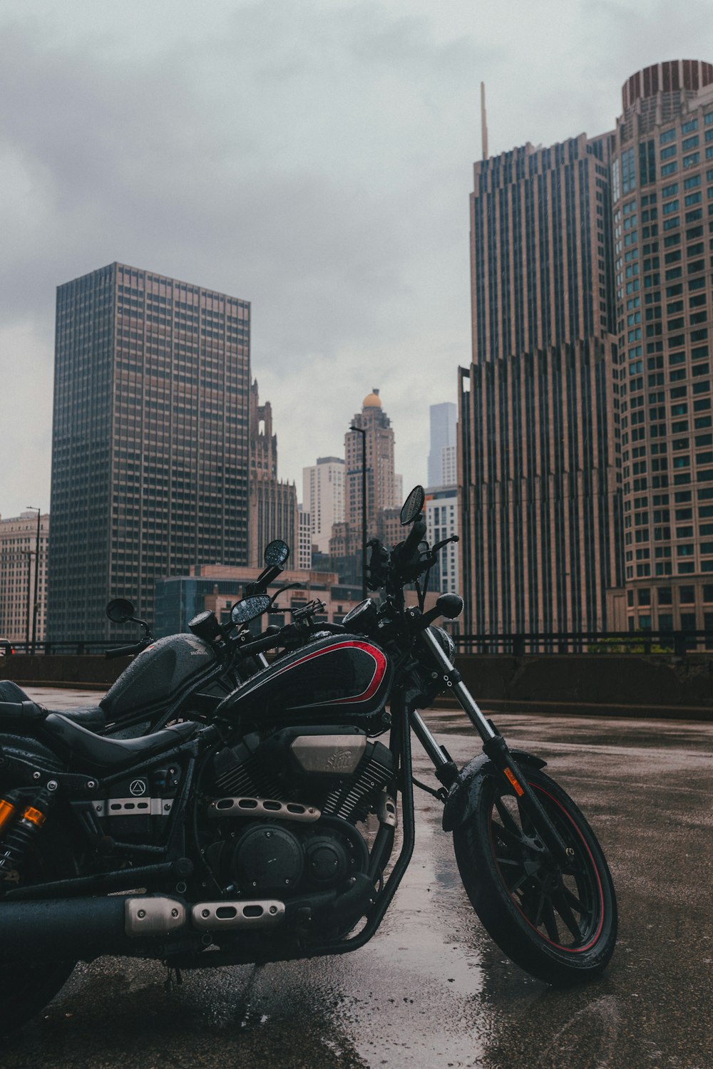 a black motorcycle parked in front of a large city