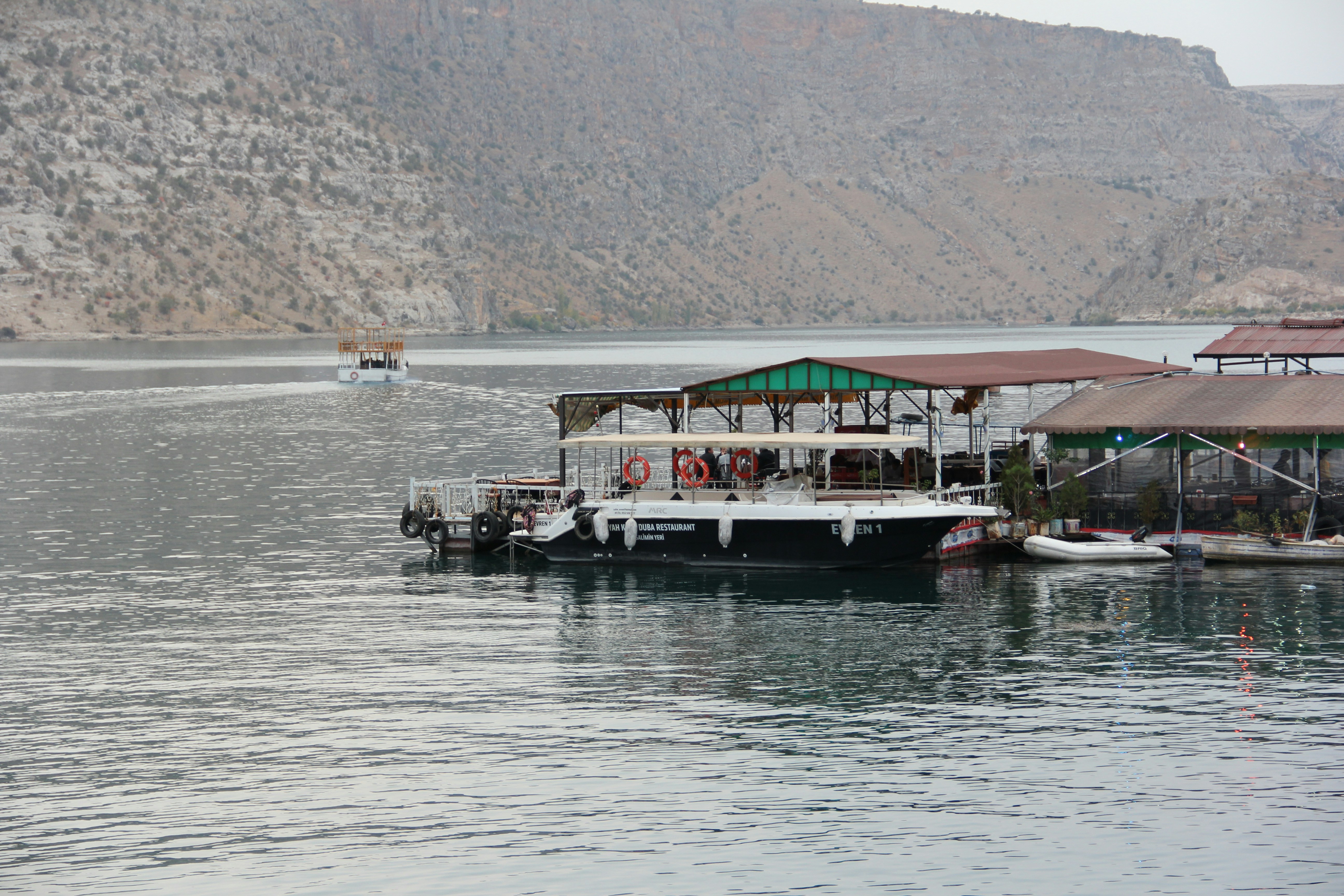 a couple of boats floating on top of a lake